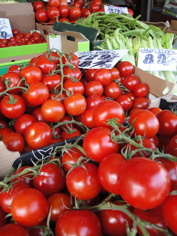 Fresh tomatoes on display at a market stall.