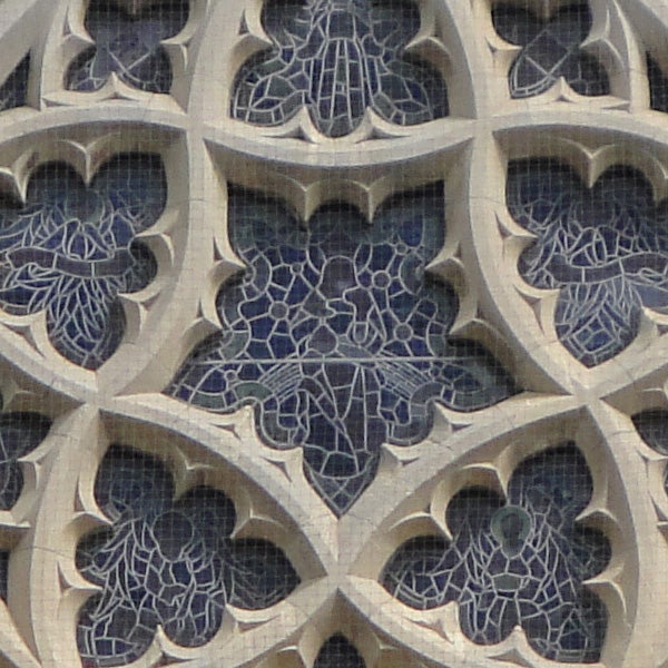 Close-up of intricate stone lattice work on a building facade