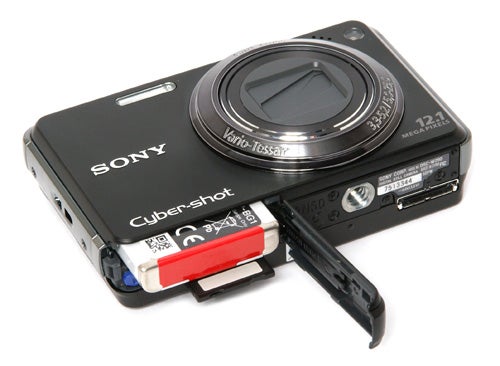 Sony Cyber-shot DSC-W290 camera with open battery compartment.