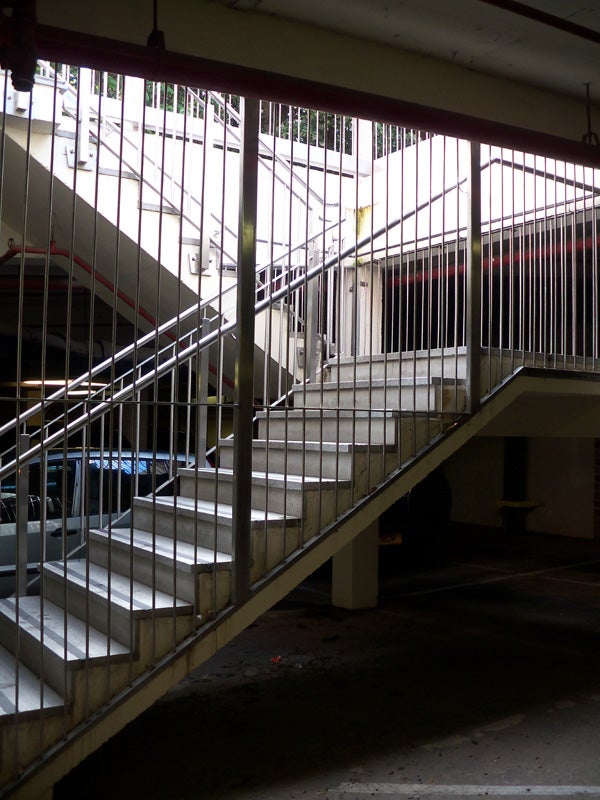 Concrete staircase structure inside a parking garage.