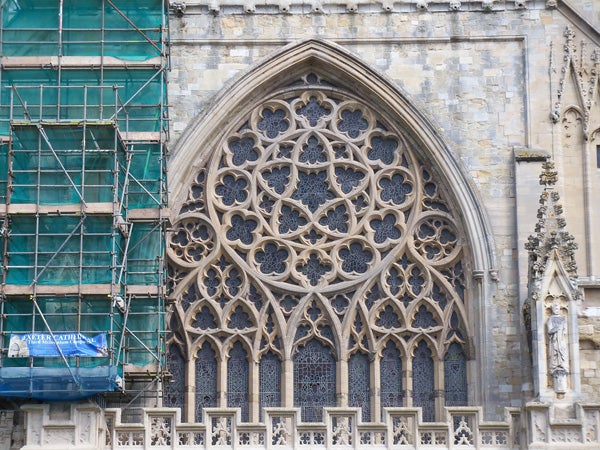 Intricate stone window tracery on gothic cathedral facade