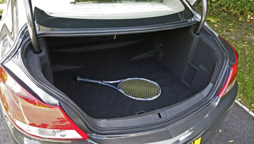 Vauxhall Insignia trunk space with a tennis racket.