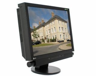 Eizo Foris FX2431 24-inch monitor on stand with buildings background.