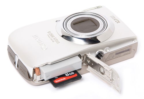 Canon IXUS 990 IS camera with open memory card slot.