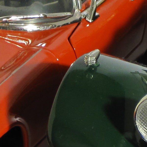 Close-up of a classic car model with reflective surfaces.