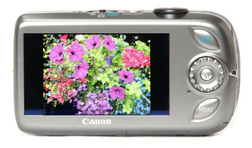 Canon IXUS 110 IS camera displaying colorful flowers on screen.