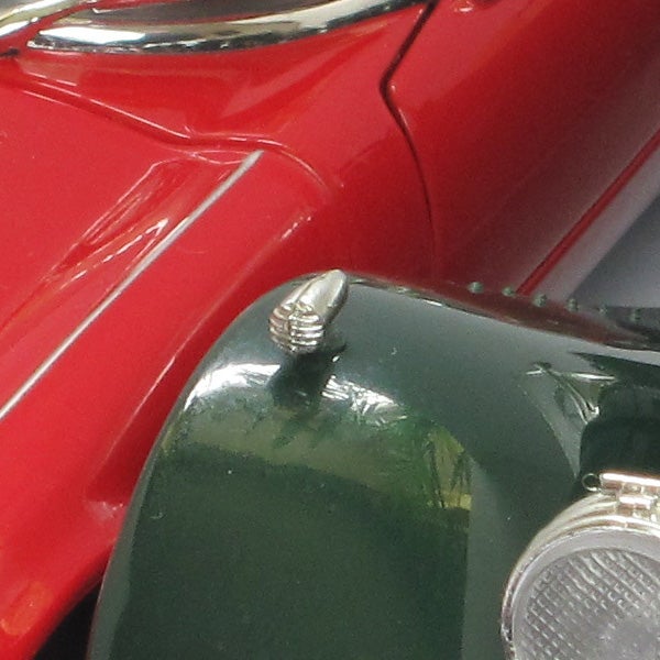 Close-up of a red and green vintage car detail.