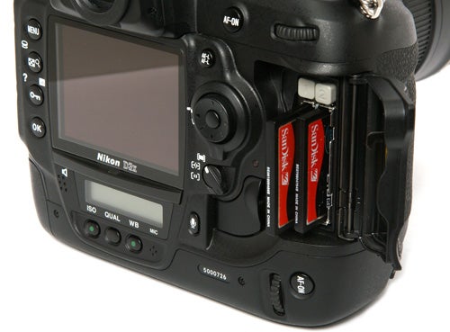 Nikon D3x camera showing open memory card slots.