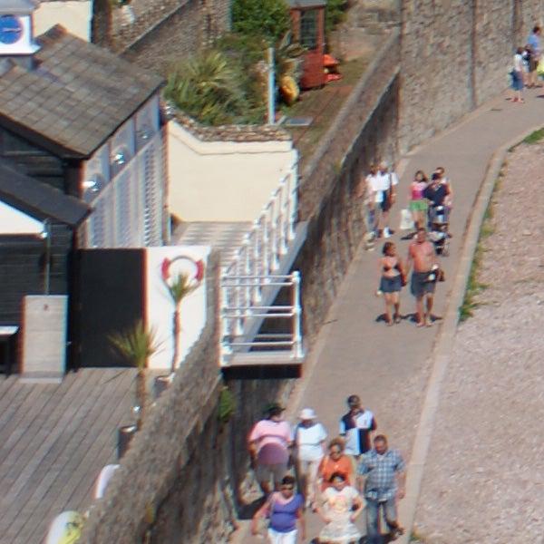 photo of people walking near a seaside promenade.