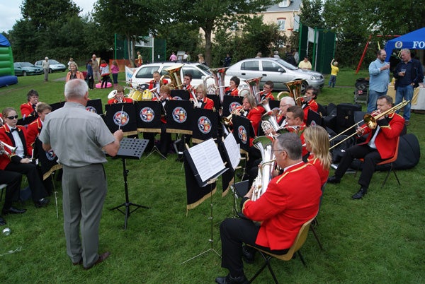 Brass band performing at an outdoor event.
