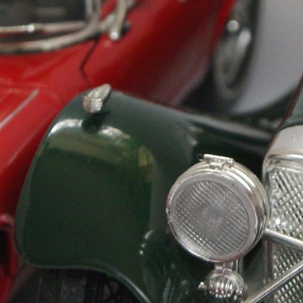 Close-up photo of a vintage red and green toy car