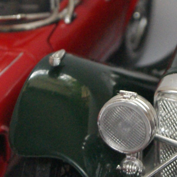 Close-up of vintage car headlight and fender
