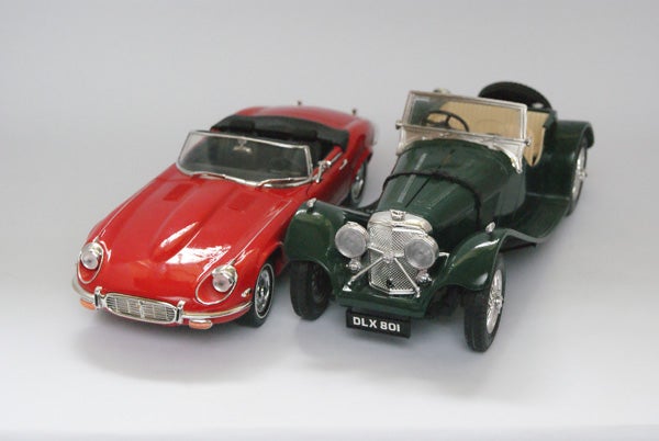 Two vintage model cars photographed on a white background.