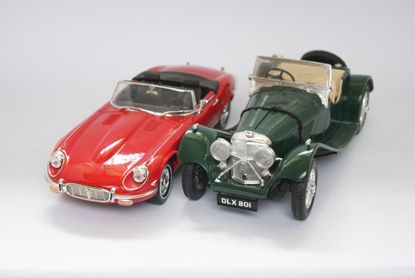 Two vintage model cars on a white background