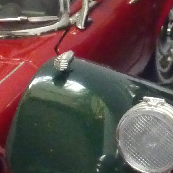 Close-up of classic car headlights and fender.