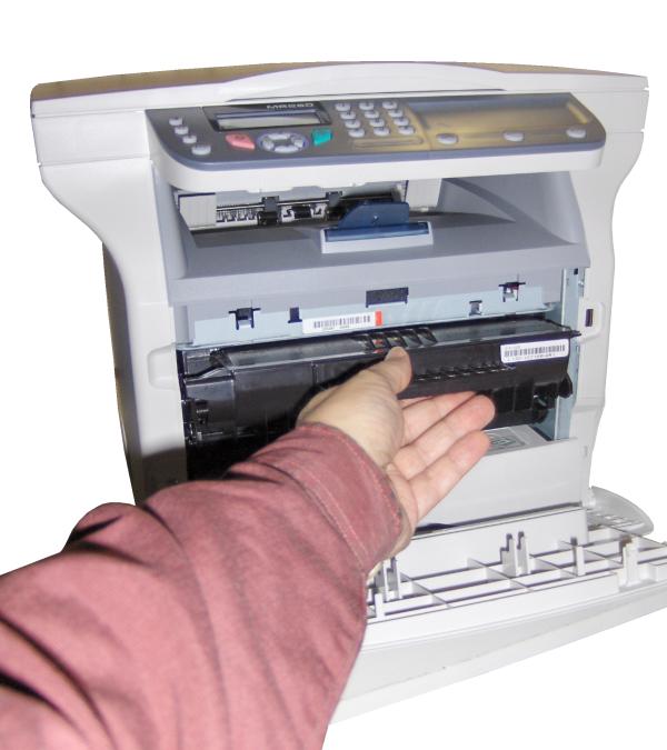 Person loading paper into OKI MB260 printer tray.