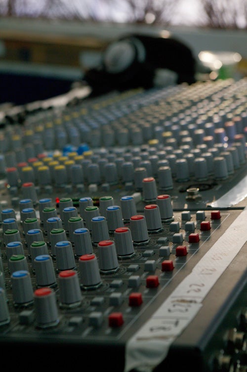 Audio mixing console with focus on control knobs.