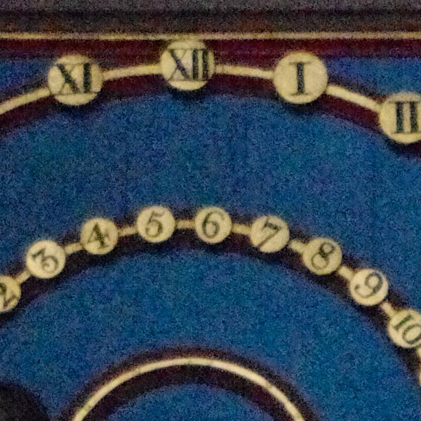Close-up of a clock face with Roman numerals.