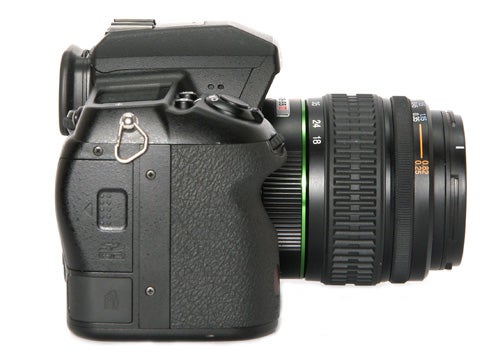 Pentax K-7 DSLR with lens against white background.