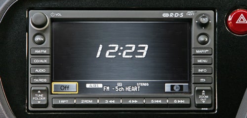 Honda Insight's dashboard showing radio and clock display.