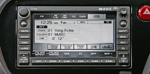 Honda Insight hybrid car multimedia interface display.Honda Insight audio system interface with track information displayed.