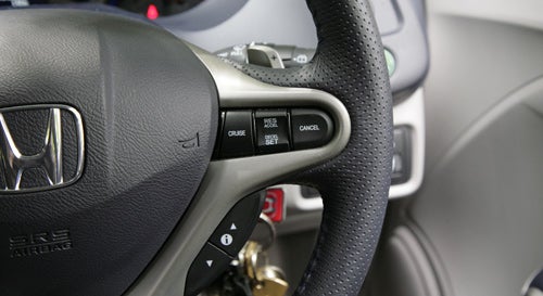 Close-up of Honda Insight's steering wheel and control buttons.