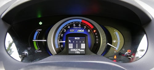 Honda Insight dashboard showing hybrid system status and speedometer.Honda Insight 1.3 ES-T Hybrid dashboard instrument cluster.