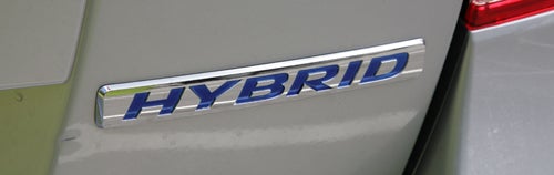 Close-up of Honda Insight hybrid badge on car.