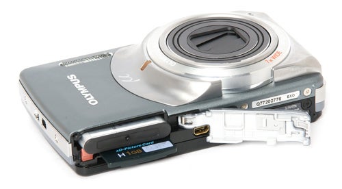 Olympus mju-7010 camera with open battery compartment.