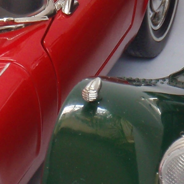 Close-up of red and green toy cars.