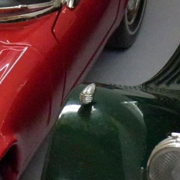 Close-up of colorful vintage cars from a low angle.