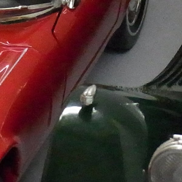Close-up of red and green vintage cars captured with Ricoh CX2.