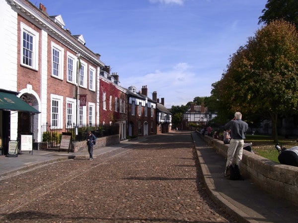 Photo taken with Ricoh CX2 showing cobbled street and historic buildings.