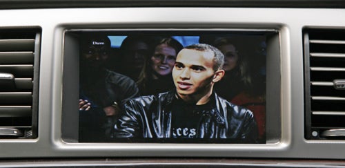 In-car entertainment system screen in Jaguar XF displaying a show.