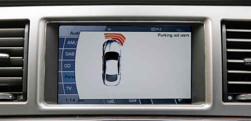 Jaguar XF dashboard screen showing parking aid alert.