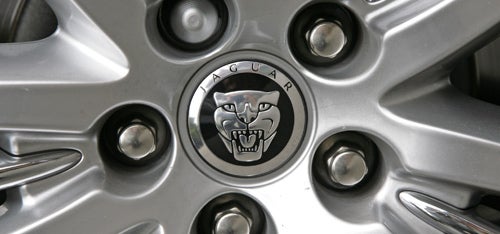 Close-up of Jaguar wheel with logo and alloy spokes.