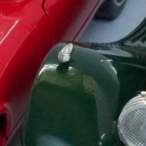 Close-up of vintage toy cars in red and green.