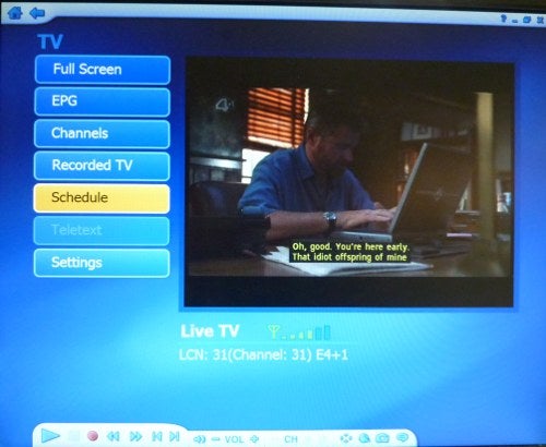 Laptop screen displaying Asus Hybrid TV Card interface with live TV.