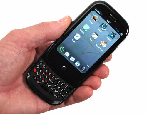 Hand holding a Palm Pre smartphone with keyboard extended.