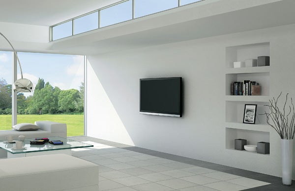 Sharp Aquos LC-40LE600E LED TV mounted in a modern living room.