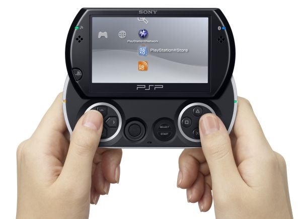 Hands holding a Sony PSPgo gaming device.