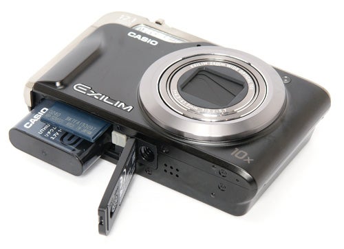 Casio Exilim EX-H10 camera with battery compartment open.
