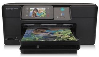 HP Photosmart Premium C309g printer with a color printout.