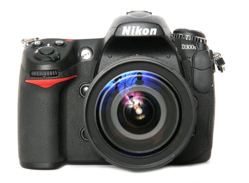 Nikon D300s DSLR camera with lens on white background.