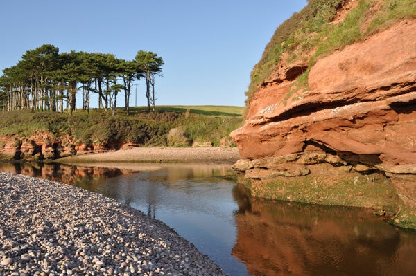 Landscape photo taken with Nikon D3000 showing river and cliffs.
