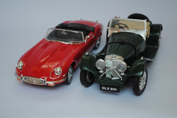Photo of two vintage toy cars on a light background