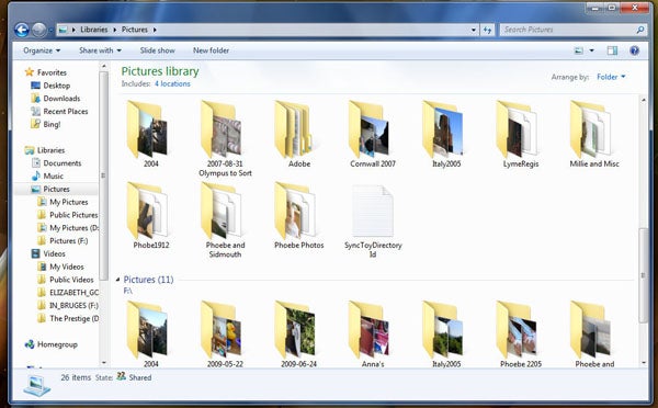Windows 7 Pictures Library interface showing folders and images.
