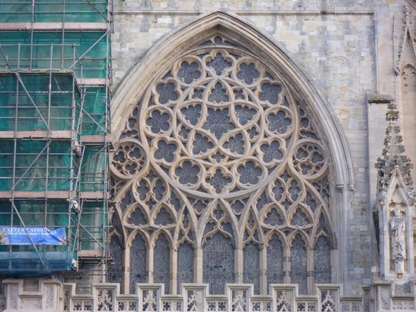 Photo of intricate cathedral architecture with scaffolding on left side.