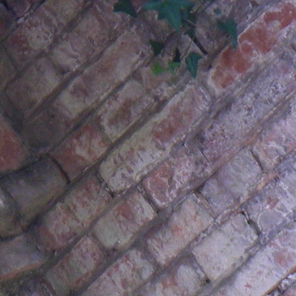 Close-up of a brick wall texture with slight vignetting.