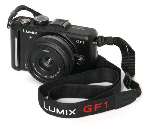 Panasonic Lumix DMC-GF1 camera with strap on white background.